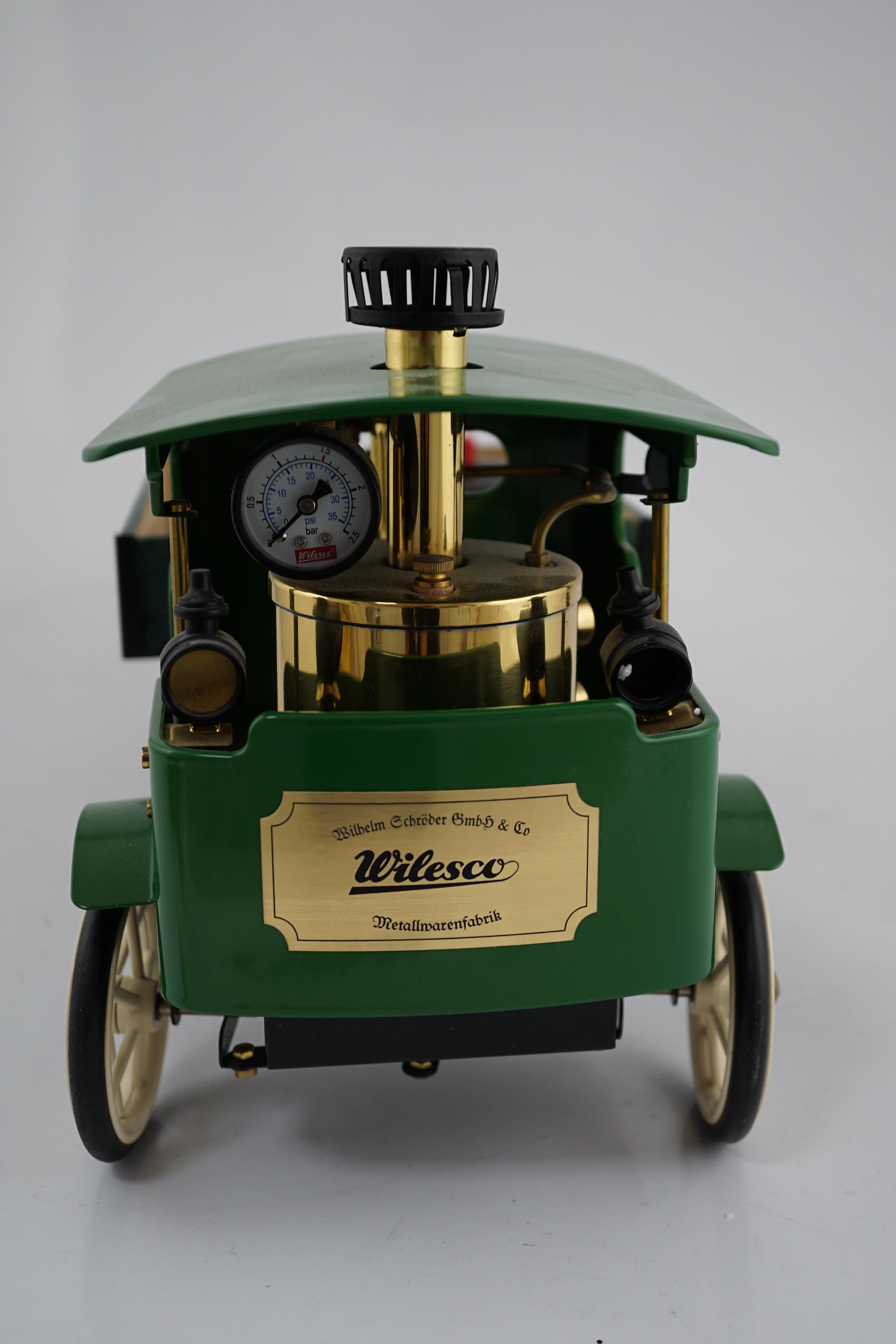 A Wilesco Steam lorry (D320) and trailer (A325), both boxed, the lorry with a pellet fired, vertical boiler fitted with water sight glasses and a pressure gauge, powering a single cylinder steam engine, also fitted with